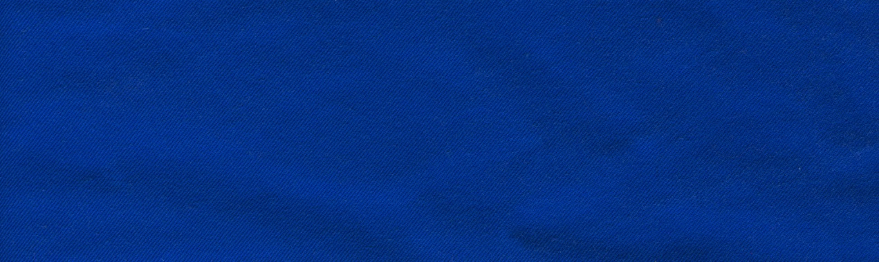 A piece of blue fabric with a regular weave like canvas. The top and sides are straight lines. The bottom is an undulating curve.