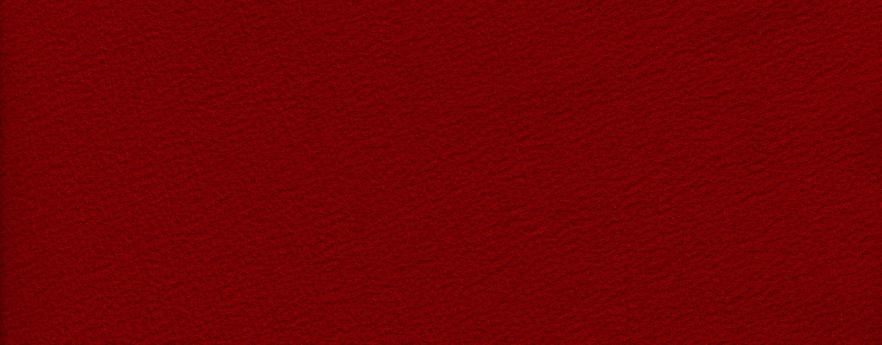 A red piece of fabric with a soft, irregular surface. The top and sides are straight lines. The bottom is an undulating curve.